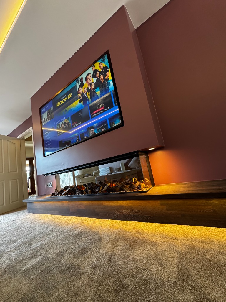 Striking contemporary media wall with a wide panoramic electric fireplace and floating wooden hearth